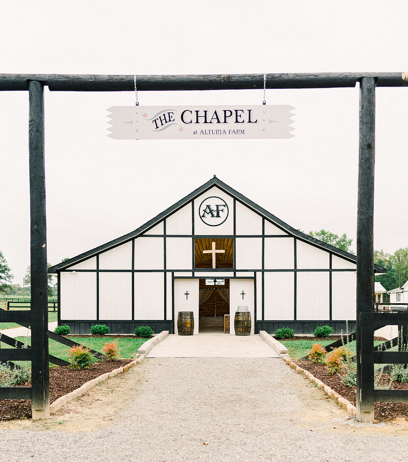 The white timber chapel and welcome gate at Alturia Farm